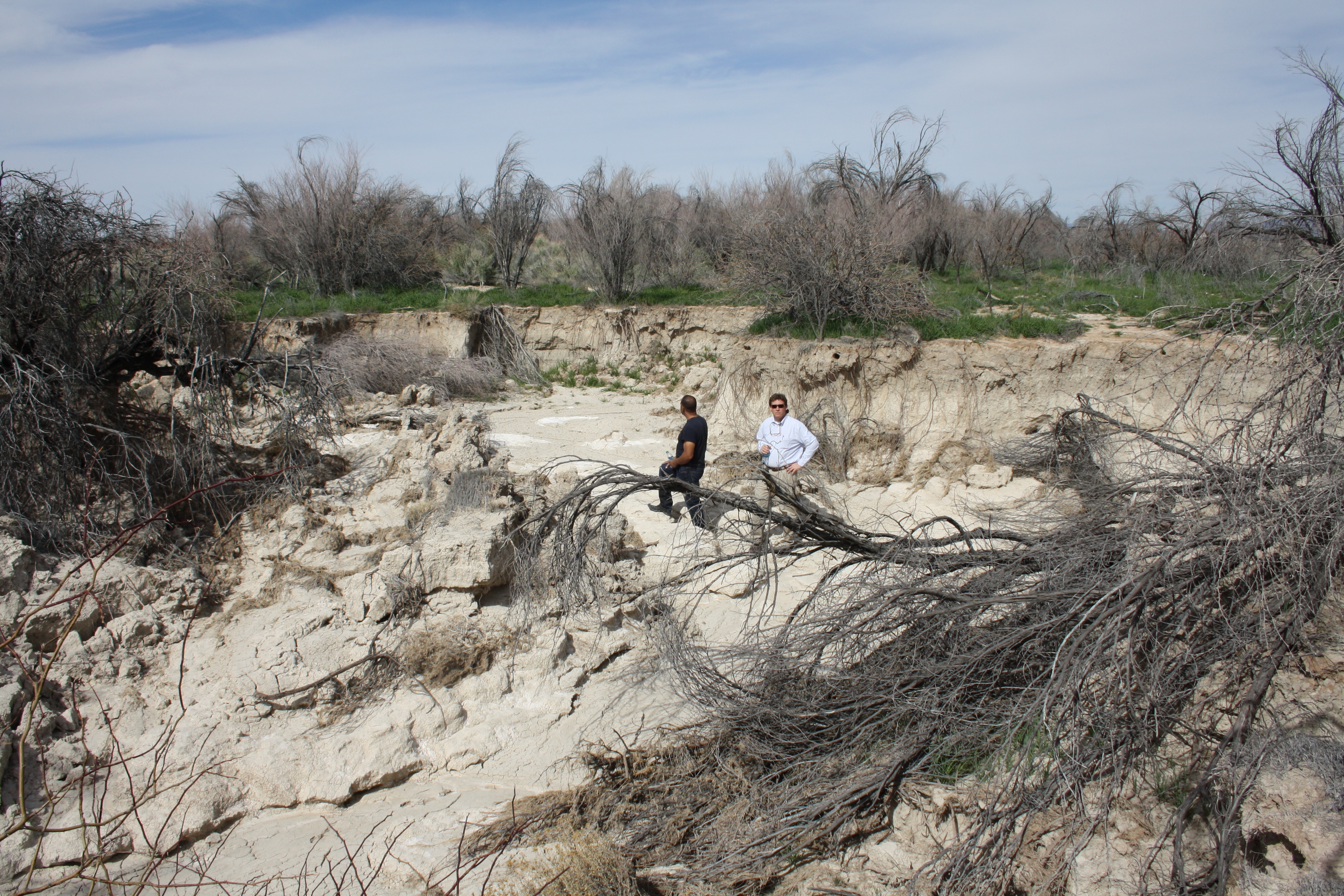 Pastor Victor Fuentes (left) stands with NPRI’s CJCL Director Joe Becker (right) in an area of the property eroded away by repeated flooding.